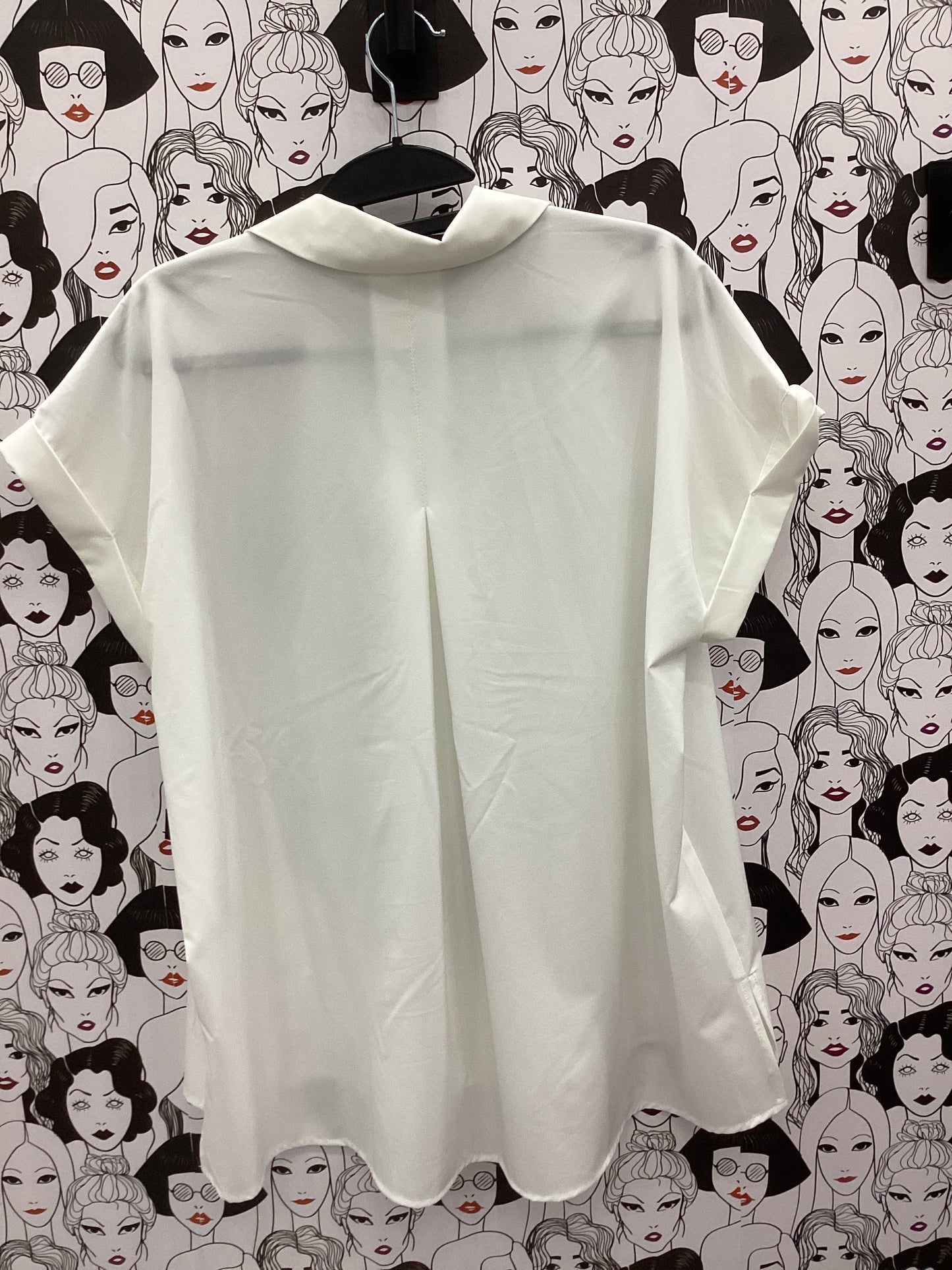 Cream sleeveless button-up